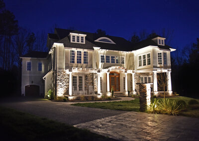 Front of two-story home with beautiful outdoor lighting